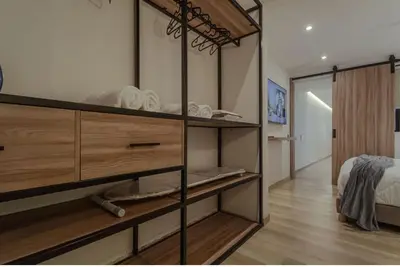 a room with wooden shelves and a bed in it at El lienzo Blanco en Medellin in Envigado