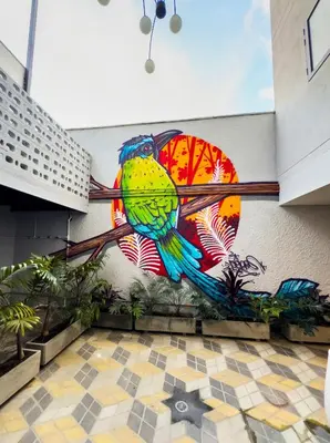 a mural of a bird on the side of a building at Habitat Ochentayuno in Medellín