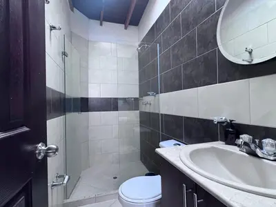 a bathroom with a sink and a toilet and a mirror at Apartamento Espacioso Belen Alameda cerca a Laureles y unidad deportiva de Belen in Medellín