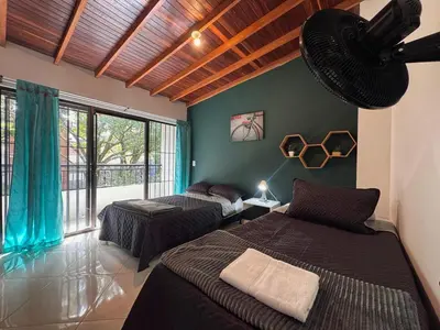a bedroom with two beds and a large window at Apartamento Espacioso Belen Alameda cerca a Laureles y unidad deportiva de Belen in Medellín