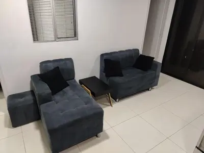 two chairs and a couch in a living room at Confortable apartamento en el corazón de Medellín in Medellín