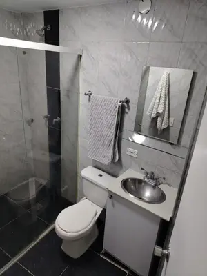 a bathroom with a toilet and a sink and a shower at Confortable apartamento en el corazón de Medellín in Medellín