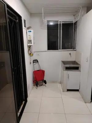 a small kitchen with a red suitcase in a room at Confortable apartamento en el corazón de Medellín in Medellín