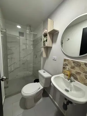 a bathroom with a toilet and a sink and a shower at Apartamentos Virginia 34 in Medellín