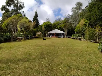 a large grass field with a tent in the distance at Casa Finca Cerca a Medellin y Aeropuerto JMC in Guarne