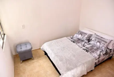 a bedroom with a bed and a chair at Your Mountain View Retreat in Medellín in Medellín
