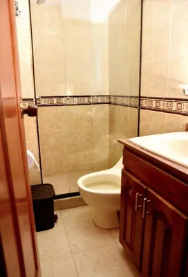 a bathroom with a toilet and a sink at Your Mountain View Retreat in Medellín in Medellín