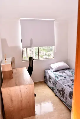 a small bedroom with a bed and a window at Your Mountain View Retreat in Medellín in Medellín