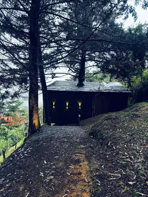a building with lights on the side of it at Mist CHALETS in Santa Bárbara