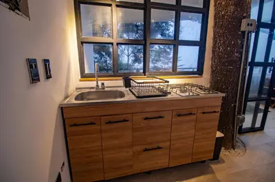 a kitchen with a sink and a window at Mist CHALETS in Santa Bárbara