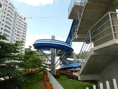 a blue water slide in a park next to a building at Apartasol vacacional con Piscinas en Santa Fe de Antioquia in Santa Fe de Antioquia