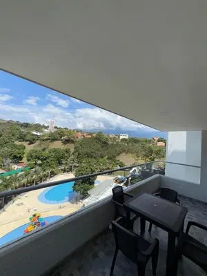 a balcony with a table and a view of a pool at Apartasol vacacional con Piscinas en Santa Fe de Antioquia in Santa Fe de Antioquia