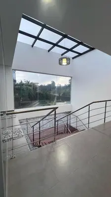 a room with a table and a large window at Villa Salomé in Guatapé in La Pradera