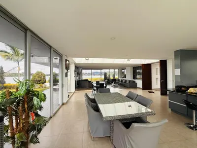 an open living room with a table and chairs at Villa Salomé in Guatapé in La Pradera