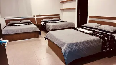 a bedroom with three beds in a room at Villa Salomé in Guatapé in La Pradera