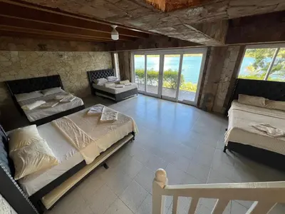 a bedroom with two beds and a couch and windows at Finca Vista Hermosa in La Pradera