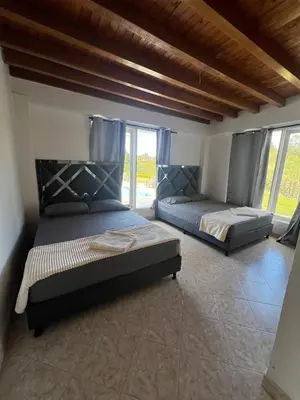 a bedroom with two beds and a large window at Finca Vista Hermosa in La Pradera
