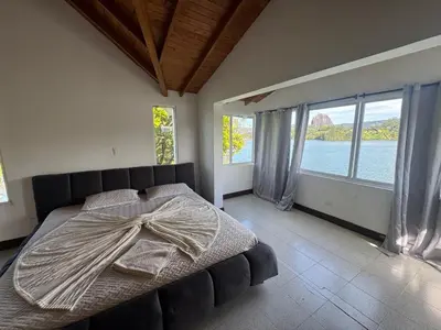 a bedroom with a large bed with a large window at Finca Vista Hermosa in La Pradera