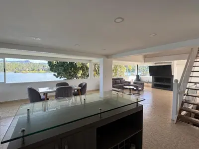 a living room with a glass table and a fireplace at Finca Vista Hermosa in La Pradera