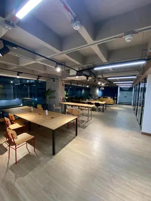 a large room with tables and chairs in it at Art, design and urban life in Medellín loft in Medellín