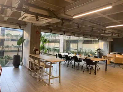 a room with tables and chairs in a building at Art, design and urban life in Medellín loft in Medellín