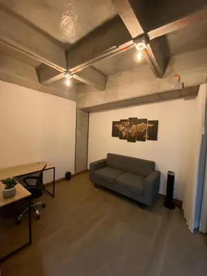 a living room with a couch and a table at Art, design and urban life in Medellín loft in Medellín