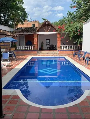 a large blue swimming pool with a house at Casa Bora Bora in Sopetran