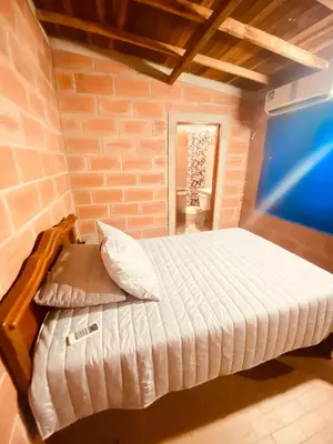 a bedroom with a bed with a laptop on it at Casa Bora Bora in Sopetran