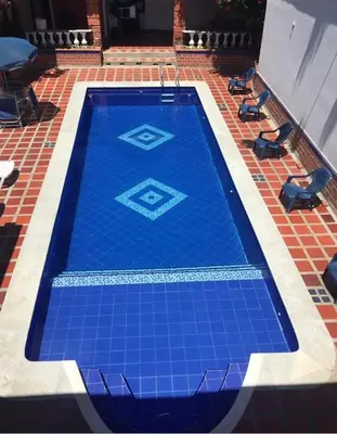 a blue tile swimming pool on a tile floor at Casa Bora Bora in Sopetran