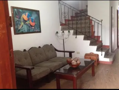 a living room with a couch and a staircase at Casa Bora Bora in Sopetran