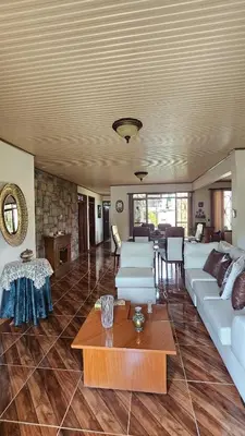 a living room with a white couch and a table at Casa campestre tranquila cerca de termales in Santa Rosa de Cabal