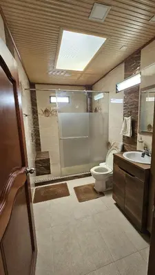 a bathroom with a shower and a toilet and a sink at Casa campestre tranquila cerca de termales in Santa Rosa de Cabal