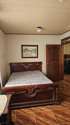 a bedroom with a large bed in a room at Casa campestre tranquila cerca de termales in Santa Rosa de Cabal