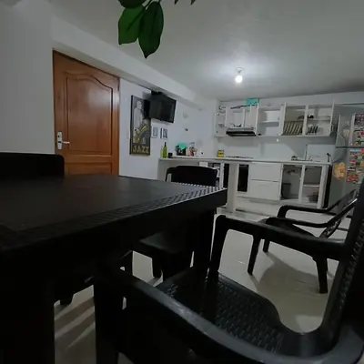 a kitchen with a table and chairs in a room at Quédate En El Punto Más Central De Manizales in Manizales