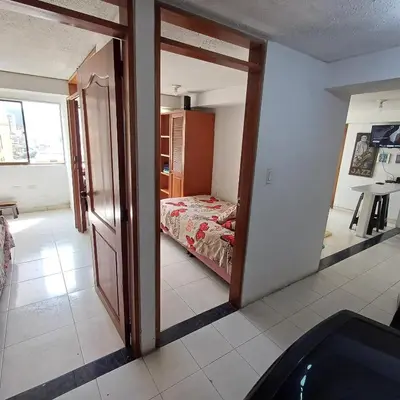 a room with a bedroom with a bed and a mirror at Quédate En El Punto Más Central De Manizales in Manizales