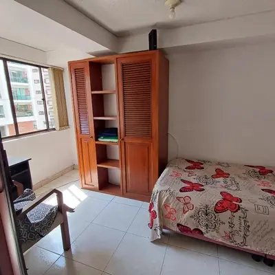 a bedroom with a bed and a cabinet and a window at Quédate En El Punto Más Central De Manizales in Manizales