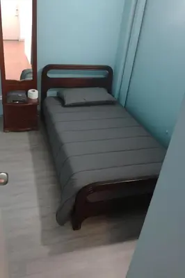 a bed in the corner of a room at Hotel Bolivar in Manizales