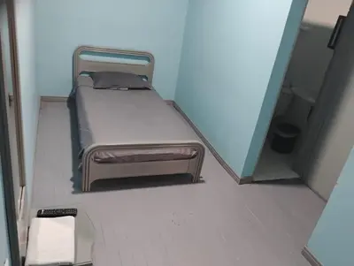 a small bed with a foot stool in a room at Hotel Bolivar in Manizales