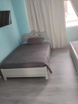 a bedroom with a bed in a room with a window at Hotel Bolivar in Manizales