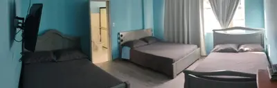 a small bedroom with two beds and a window at Hotel Bolivar in Manizales