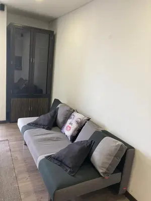 a couch in a room with pillows on it at Beautiful Loft close to airport,pool gym & parking in Rionegro