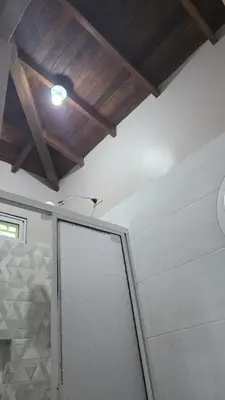 a bathroom with a shower with a wooden ceiling at Finca La Rosa in Ebéjico