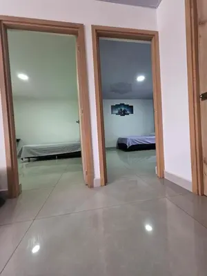 a room with two sliding doors and a room with a bed at Finca La Rosa in Ebéjico