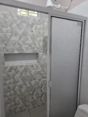 a shower with a glass door in a bathroom at Finca La Rosa in Ebéjico