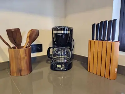 a blender sitting on top of a counter with knives at Cabaña privada Reserva Rio Blanco Manizales in Manizales