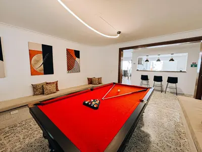 a red pool table in a room with chairs at casa patio bonito in Medellín