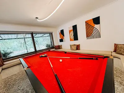 a room with a red pool table in it at casa patio bonito in Medellín