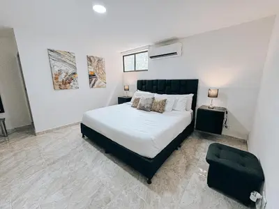 a bedroom with a bed and a chair in it at casa patio bonito in Medellín