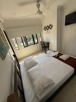 a large bed in a room with a window at 5ta HOTEL CONTINENTAL in Puerto Boyacá