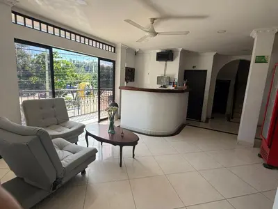 a living room with two chairs and a table at 5ta HOTEL CONTINENTAL in Puerto Boyacá